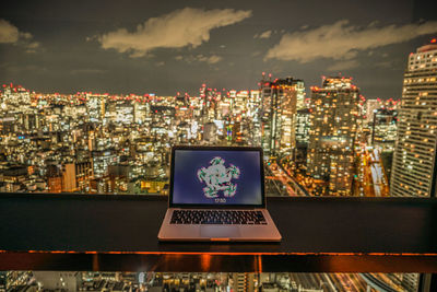 High angle view of illuminated city buildings against sky