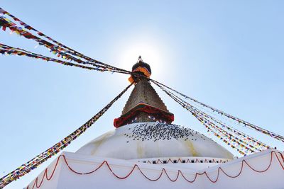 Low angle view of carousel against clear sky