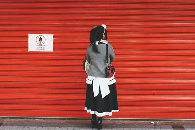 Rear view of a woman standing on ground