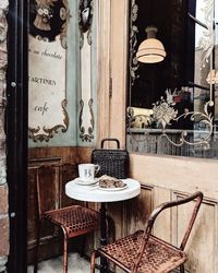 Table and chairs in cafe against building