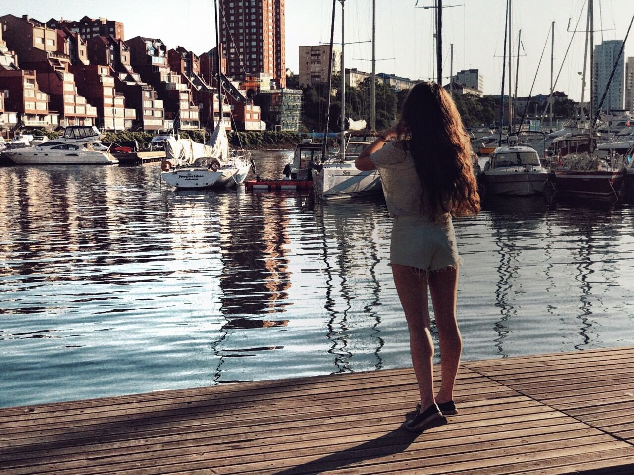 water, rear view, real people, one person, leisure activity, women, lifestyles, long hair, built structure, full length, architecture, day, outdoors, building exterior, nautical vessel, young adult, young women, adult, adults only, people