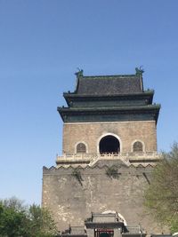 Low angle view of built structure against clear blue sky