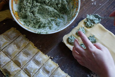 High angle view of person preparing food on table