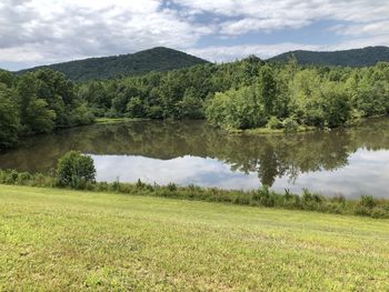 Scenic view of lake and trees against sky