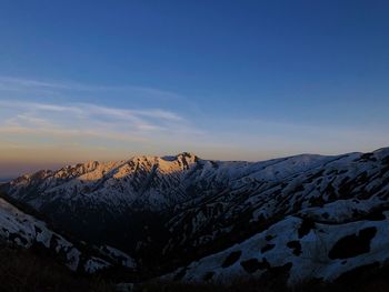 Scenic view of snowcapped mountains against sky during winter