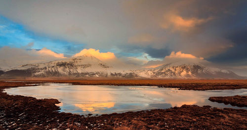 Scenic view of lake against sky during winter