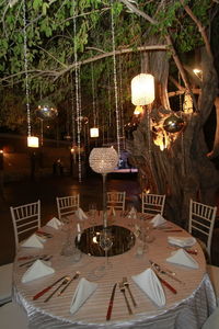 Table and chairs in restaurant at night