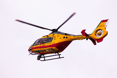 Low angle view of yellow flying against clear sky