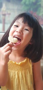 Close-up portrait of cute girl eating food