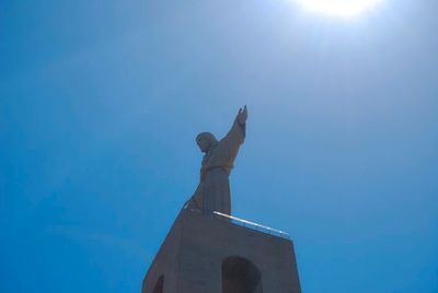Low angle view of statue against blue sky