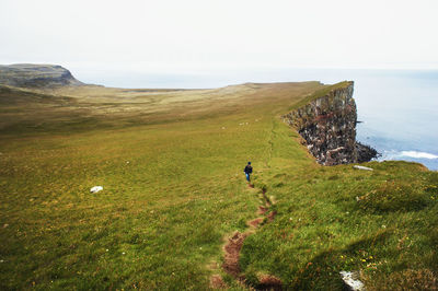 Scenic view of bird cliffs iceland north atlantic ocean , woman walking landscape nature latrabjarg
