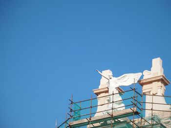 Low angle view of built structure against clear blue sky