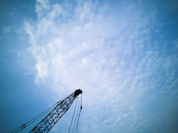 Low angle view of crane against blue sky