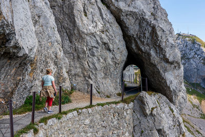 Rear view of people walking on rock