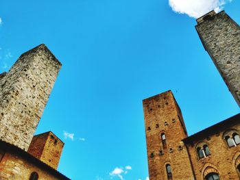 Low angle view of old building against blue sky