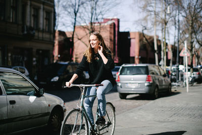 Man with bicycle on road in city