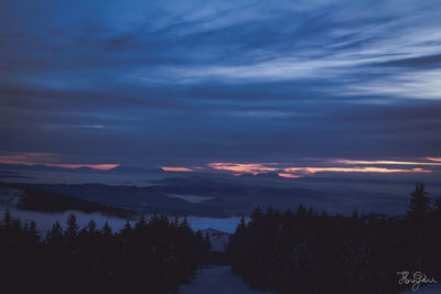 Scenic view of landscape against sky during winter