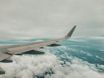 Cropped image of airplane wing against sky