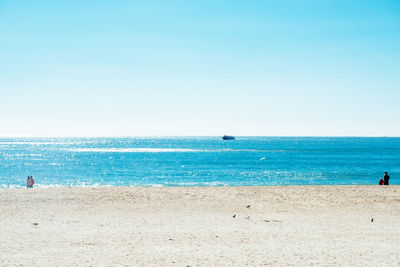 Scenic view of sea against clear blue sky