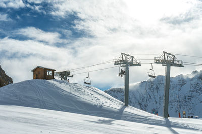 Chairlifts rising into the station at the top of the mountain on a sunny day in les arcs