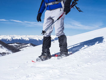 Snowshoeing scene in the italian alps