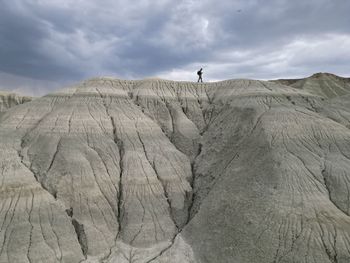 Low angle view of man standing on rock formations