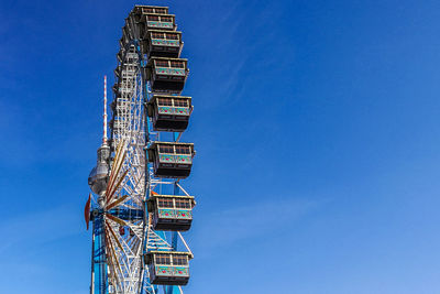 Low angle view of crane against blue sky