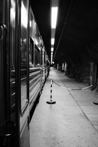 Train at railroad station platform during night