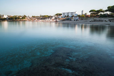 Scenic view of sea and buildings in city