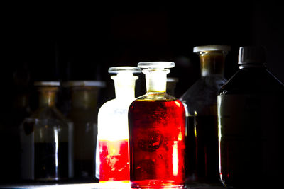 Close-up of bottles against black background