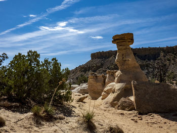 Rock formations on landscape against sky