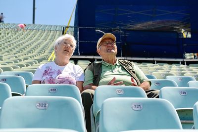 Couple sitting on chairs at auditorium