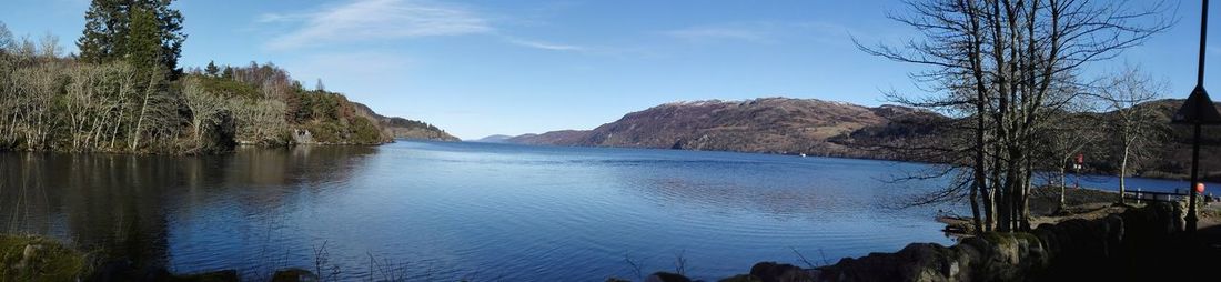 Panoramic view of sea and mountains against sky