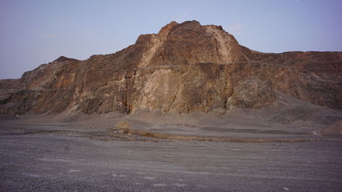 Rock formations on landscape against clear sky