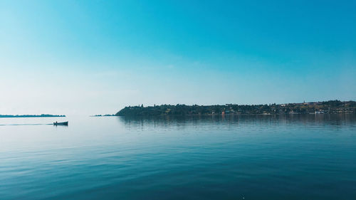 Scenic view of sea against clear blue sky