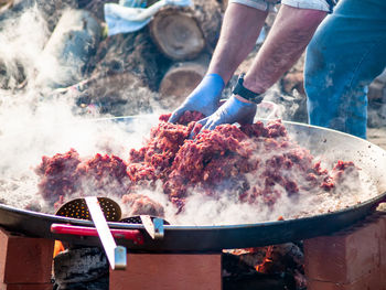 Man preparing food at market stall