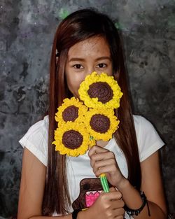Portrait of girl holding knitted flower