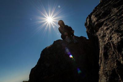 Low angle view of rock formation against clear blue sky
