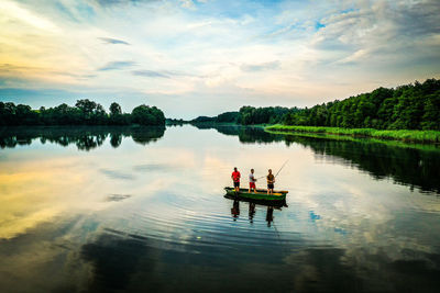 Scenic view of lake against sky am boat fishing