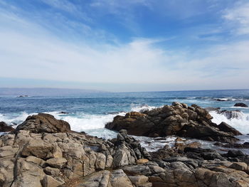 Rocks on beach against sky