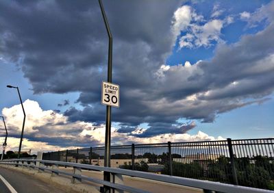 Road sign against sky