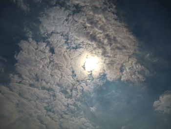 Low angle view of moon against cloudy sky