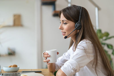 Side view of businesswoman working in office