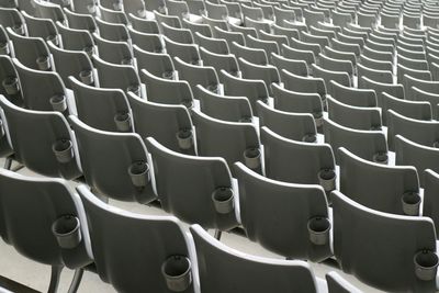 Full frame shot of empty white seats at soccer stadium