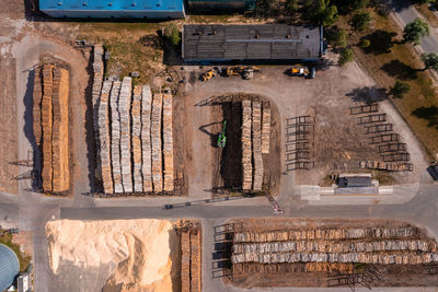 Wood pile wall outside factory with at a industrial patio