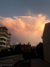 Low angle view of buildings against sky at sunset