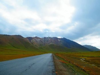 Empty road leading towards mountains