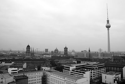 Fernsehturm overlooking cityscape against clear sky