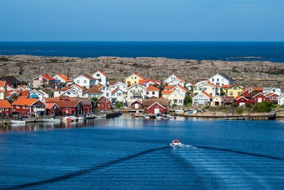 Scenic view of sea by buildings against sky