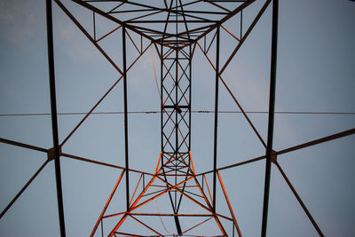 Low angle view of electricity pylon against clear sky